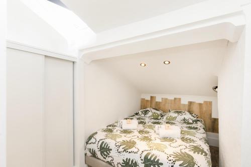 une chambre avec un lit dans une pièce blanche dans l'établissement Cosy & design à côté du Palais et des plages, à Cannes
