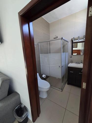 a bathroom with a toilet and a shower and a sink at Casa Xïri. Matanchén, San Blas. in San Blas
