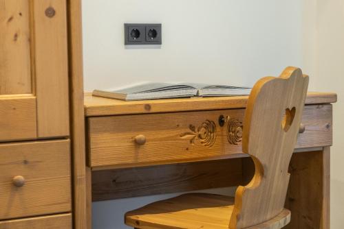 a wooden desk with a book on top of it at CHALET ARIA Stay Mountain Relax in Arabba