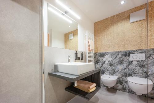 a bathroom with a sink and a toilet at CHALET ARIA Stay Mountain Relax in Arabba