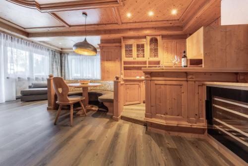 a kitchen with a table and a fireplace at CHALET ARIA Stay Mountain Relax in Arabba