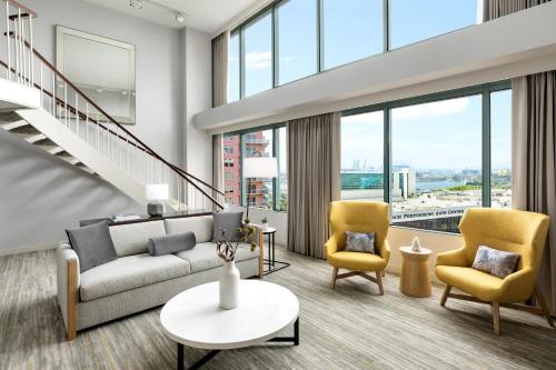 a living room with a couch and two chairs at The Westin Long Beach in Long Beach