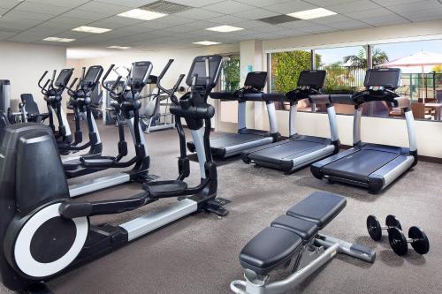 a gym with rows of treadmills and exercise bikes at The Westin Long Beach in Long Beach
