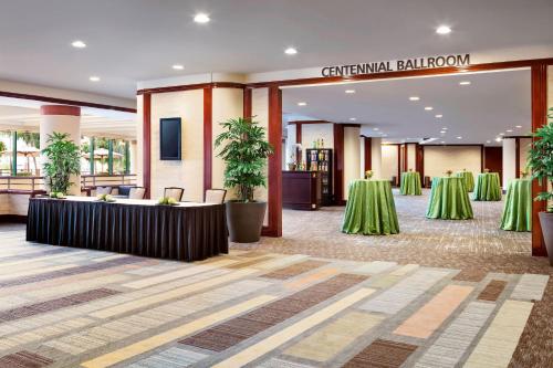 a banquet hall with green tables and a sign at The Westin Long Beach in Long Beach
