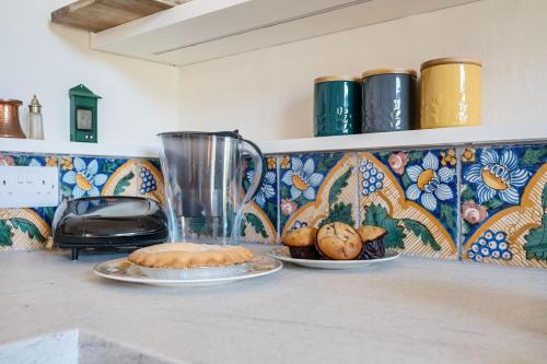 a counter with two plates of food and a blender at Artist's Studio in Piddlehinton