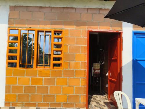 a brick building with an open door and a window at Villa Milena in Santa Helena