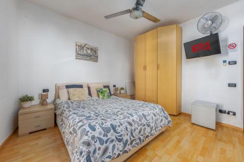 ein Schlafzimmer mit einem Bett und einem Holzschrank in der Unterkunft TiglioExperienceComo in Como