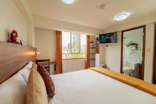 a hotel room with a bed and a bathroom at Dreams Boutique Hotel Cusco in Cusco