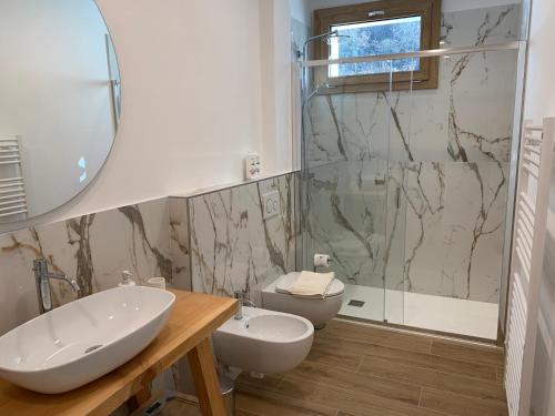 a bathroom with a sink and a toilet and a shower at IL COMO' DELLA CIVETTA - Nido della Civetta in Villa di Tirano