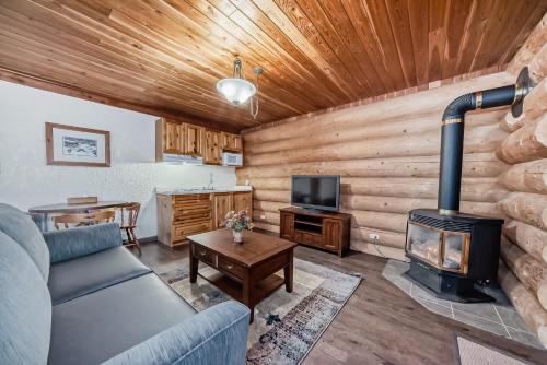 a living room with a couch and a stove at Terracana Ranch Resort in Tete Jaune Cache