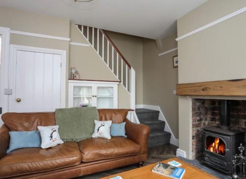a living room with a couch and a fireplace at Hafan Glyd charming cozy cottage in Conwy in Conwy