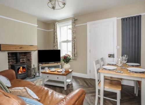 a living room with a couch and a table at Hafan Glyd charming cozy cottage in Conwy in Conwy