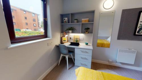 a bedroom with a desk and a window and a bed at iQ Daisy Bank Manchester in Manchester