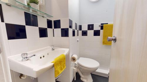 a white bathroom with a sink and a toilet at iQ Daisy Bank Manchester in Manchester