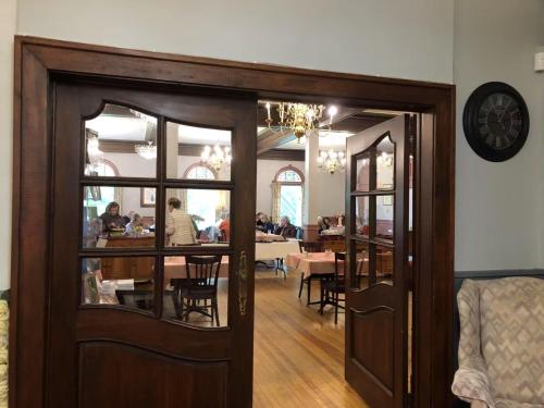 a dining room with a table and a clock on the wall at Braeside Country Inn in Pictou