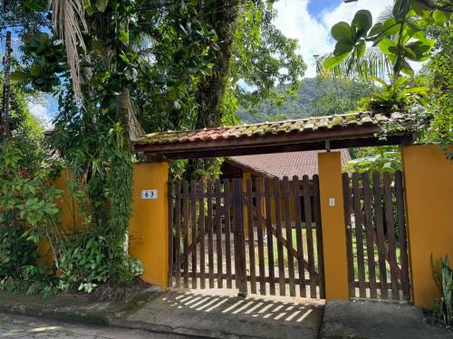 a wooden gate in front of a house at Casa Amarela in São Sebastião