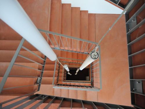 a spiral staircase in a building with a light at Hotel Frauenfeld in Frauenfeld