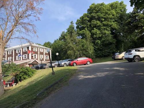 a group of cars parked in front of a building at Braeside Country Inn in Pictou