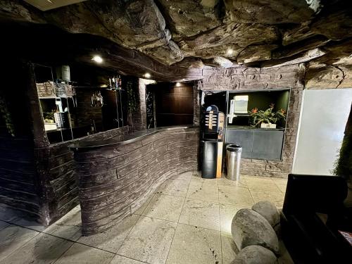 a restaurant with a brick wall and a refrigerator at Cachoeiras Motel - Hotel in Sao Paulo