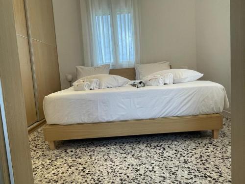 a bedroom with a large bed with white sheets at Studios Angeliki in Lassi