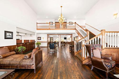 a living room with a couch and a staircase at Best Western Newberry Station in La Pine