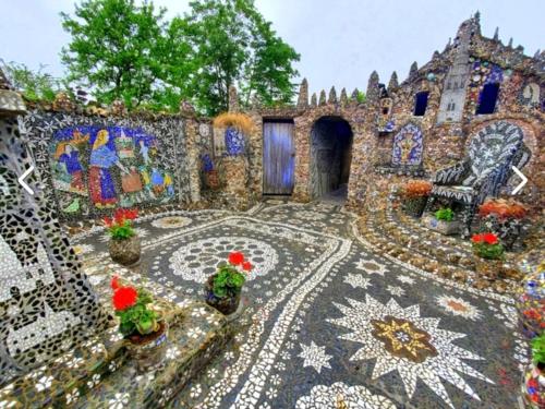 a house with a mosaic floor with potted plants at Love Room Charnelle, Chic, Hammam, Clim in Chartres