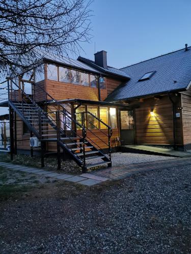 a house with a staircase in front of it at Noclegi Święta Katarzyna ,, Pod Jeleniami "prawdziwymi in Święta Katarzyna