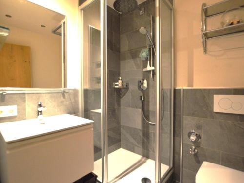a bathroom with a shower and a sink at Wachtlnest in Maria Alm am Steinernen Meer