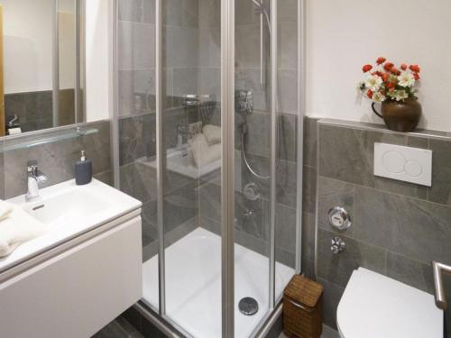 a bathroom with a shower and a sink at Wachtlnest in Maria Alm am Steinernen Meer