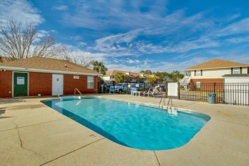 a swimming pool in a yard with a house at Birding, Beaches and More Cozy Gautier Condo in Gautier
