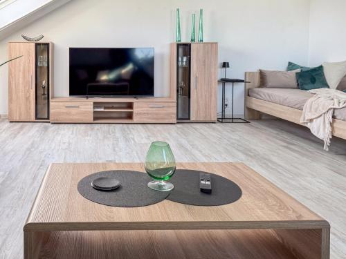 a living room with a wine glass on a table at Ferienwohnung Brigitte in Nördlingen