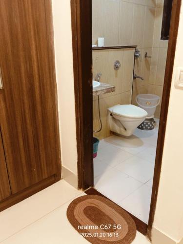 a bathroom with a toilet and a sink at RTS HOTEL & Spa in New Delhi