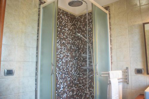 a bathroom with a shower with a glass door at B&B Terrazza dell'Etna in Mascalucia