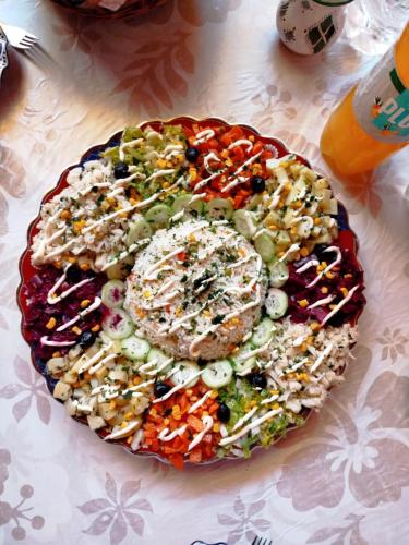 a plate of food with vegetables on a table at Appartement a louer MASSINI in Tiznit
