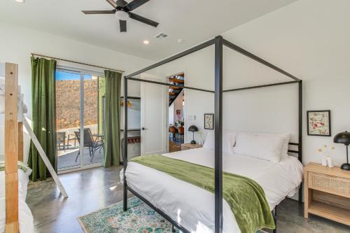 a bedroom with a canopy bed and a balcony at Walk to Lake Home with Game Room in Medicine Park! in Medicine Park