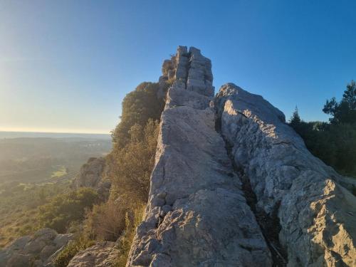 a rock formation on the side of a mountain at Les Garrigues de la Vallée des Baux in Paradou
