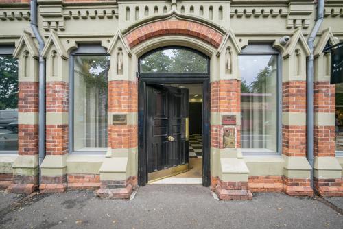 an entrance to a building with a black door at Contemporary 1-Bed Apartment in The Bakery, Ormeau Road in Belfast
