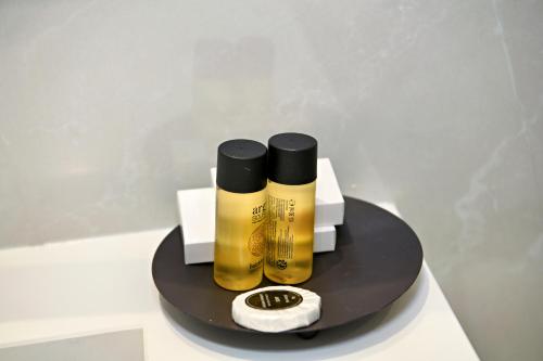 a black and yellow bottle of champagne on a table at Hotel Restaurant Dreri in Tirana
