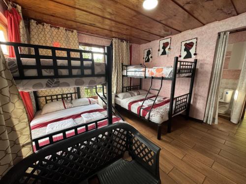 a room with two bunk beds and a window at Hanna Suites in Panajachel