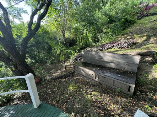 a wooden bench sitting on top of a hill at Hanna Suites in Panajachel