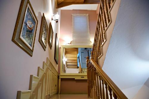 a hallway with a staircase with wooden railings at Hotel Restaurant Dreri in Tirana