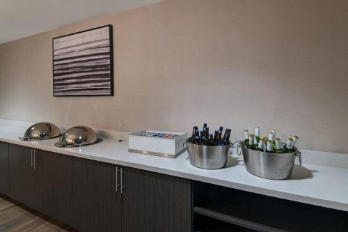 a counter with two buckets of wine bottles on it at Residence Inn Shreveport Airport in Shreveport