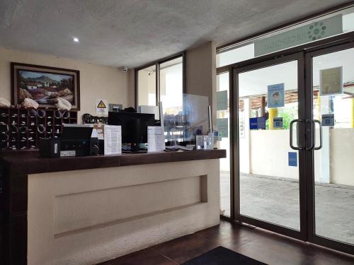 a restaurant with a counter and a door to a store at Ashly Boulevard in Acapulco