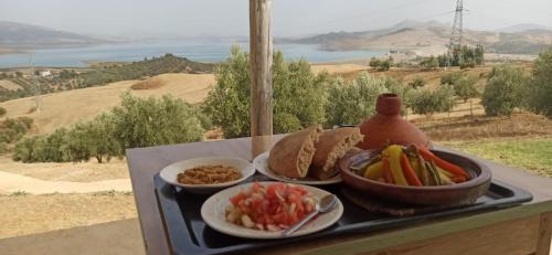 a tray of food with bowls of vegetables and dips at La Belle Etoile in Ouazzane