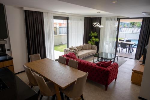 a living room with a couch and a table at Villa merkez havuzlu odalarbanyolu in Cesme
