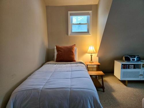 a small bedroom with a bed and a window at Charming, Pet-friendly Lake front Retreat WiFi in Ferndale