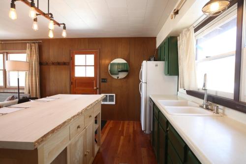 a kitchen with two sinks and a refrigerator at Gorgeous Views, Fishing at Private Cabin on Pelican Lake, Orr MN in Orr