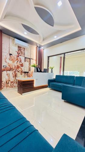 a living room with blue couches and a couch at Hotel AL Taj , Agra in Agra