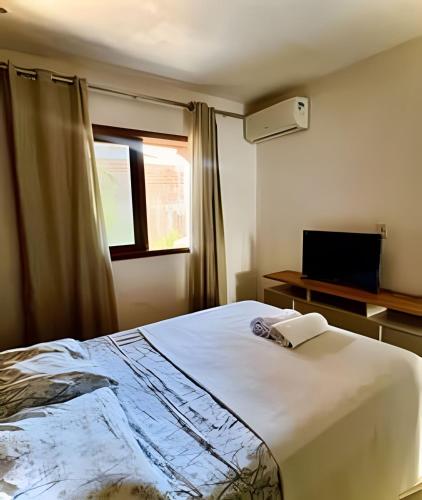 En eller flere senge i et værelse på Apto Sossego - Barbosa acomodações