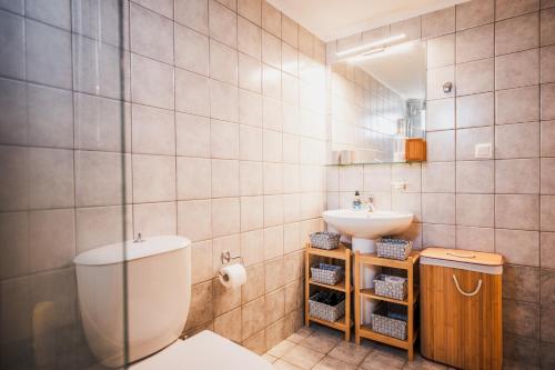 a bathroom with a toilet and a sink at Cretan Odyssey Maisonette in Maleme